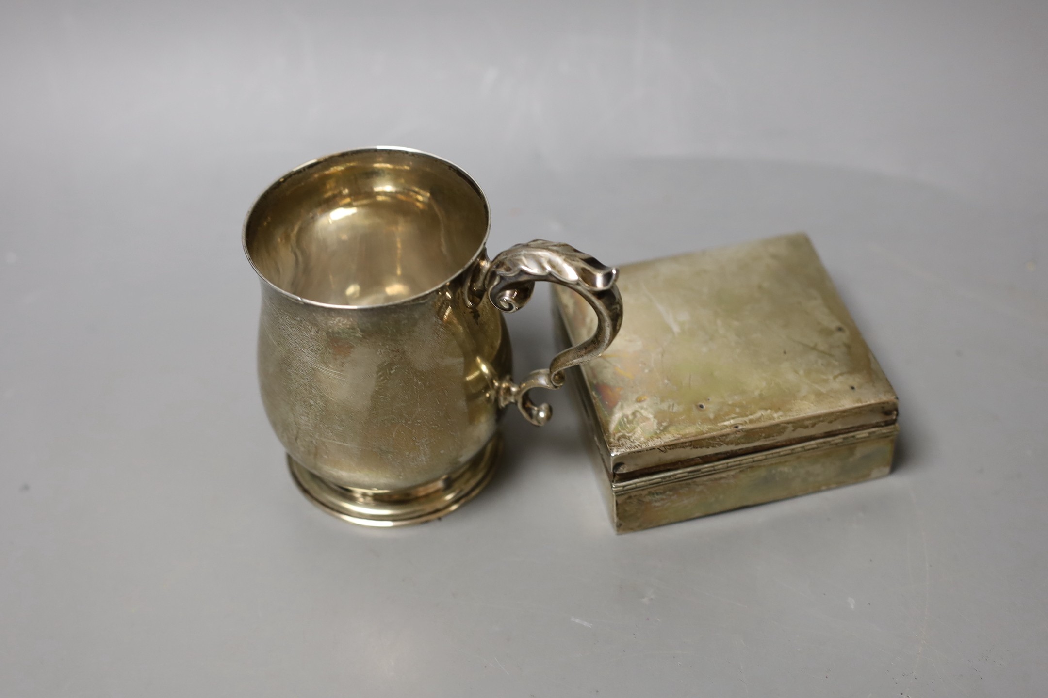 A George V silver christening mug, London, 1934, 95mm and a silver mounted cigarette box.